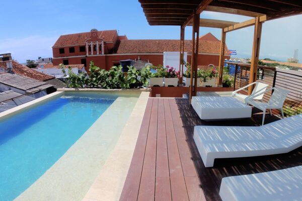 Pool with beds and wooden roof over beds