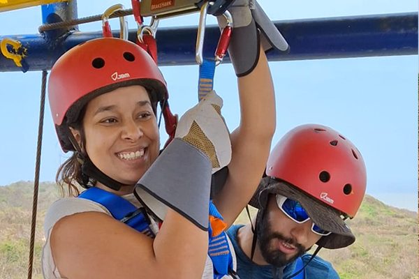 Woman wearing red helmet preparing for zipline ride in Cartagena with guide